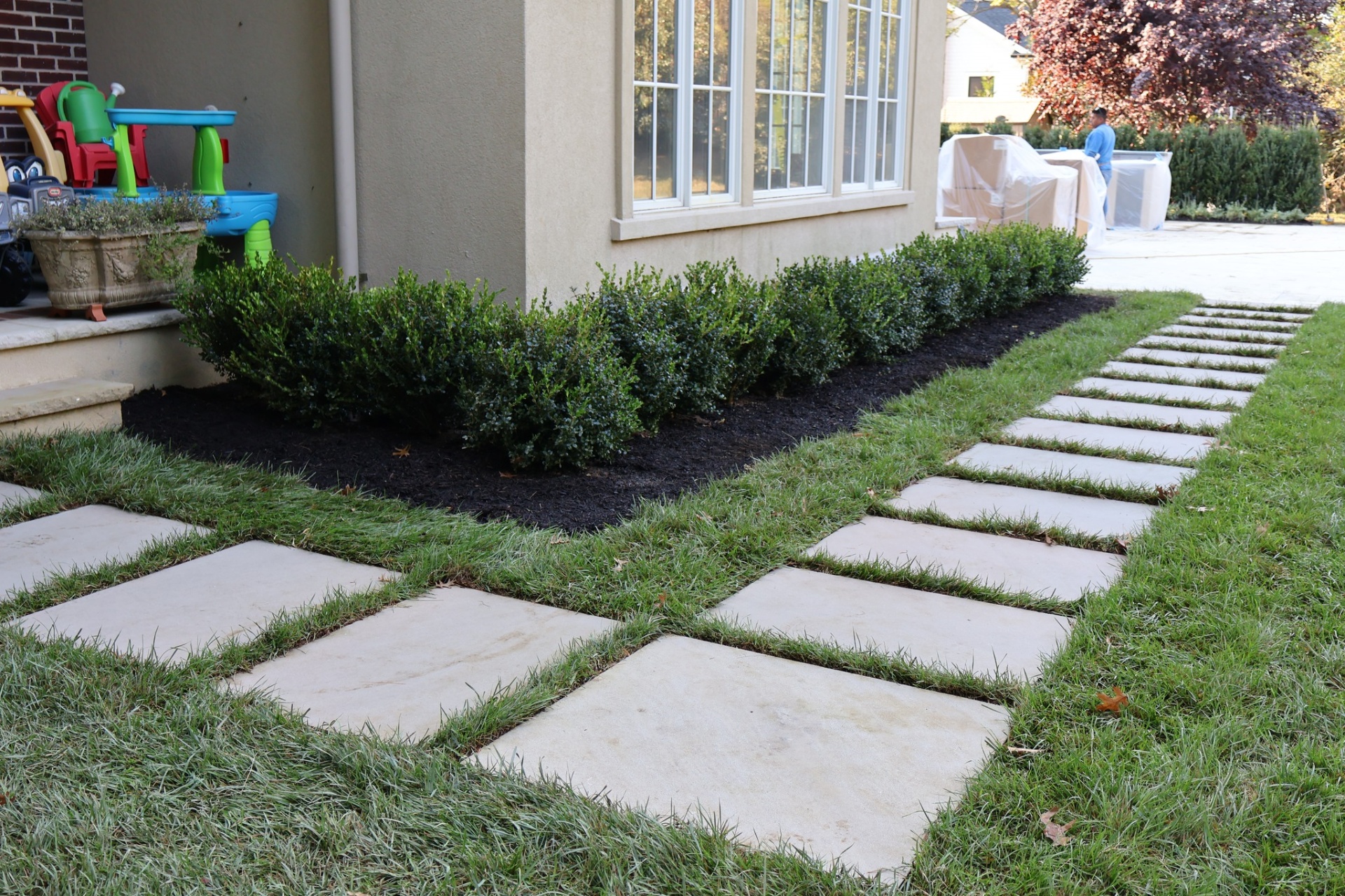 Bluestone stepping-stone walkway with boxwood border